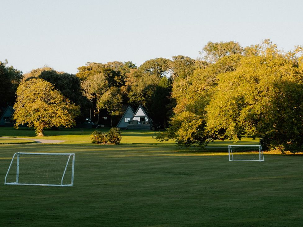 A soccer field with two goals and trees at St Ives Lodge 3 Spa Praze-An-Beeble