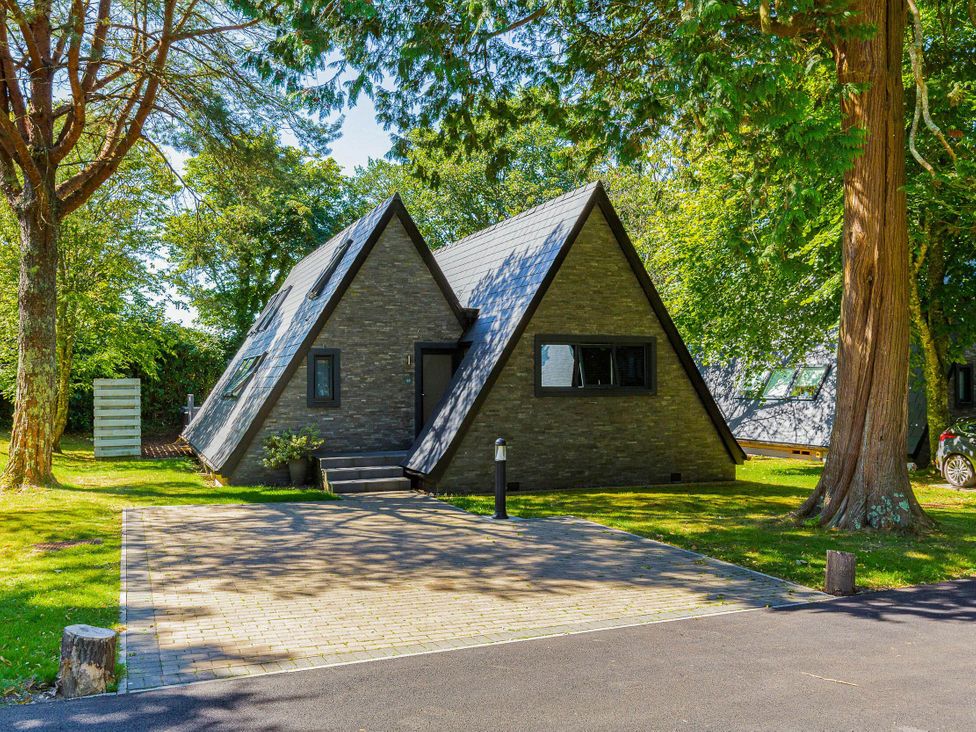 A house with a pitched roof and a paved driveway at Glass Lodge in Praze-An-Beeble