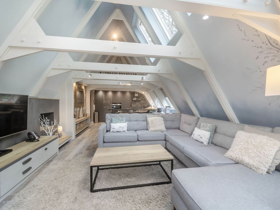 A living room with a sofa and coffee table at Glass Lodge in Praze-An-Beeble