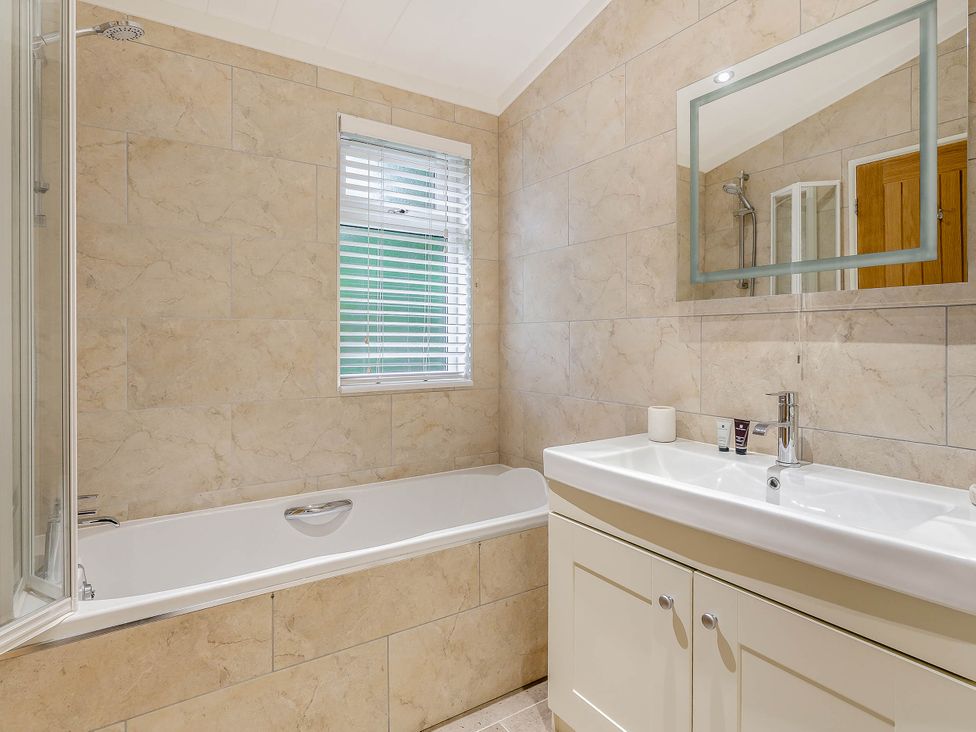 A bathroom with a bathtub and sink at Aubyn Lodge Spa Praze-An-Beeble