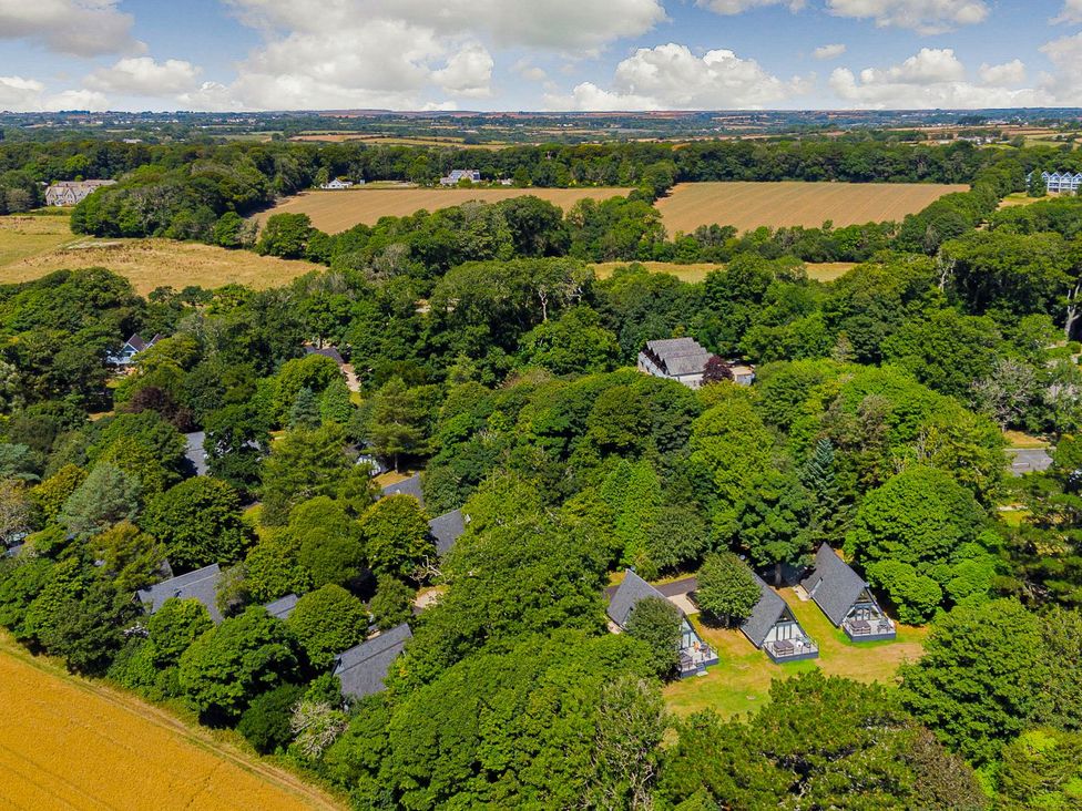 An aerial view of houses surrounded by trees and fields at Aubyn Lodge Spa in Praze-An-Beeble