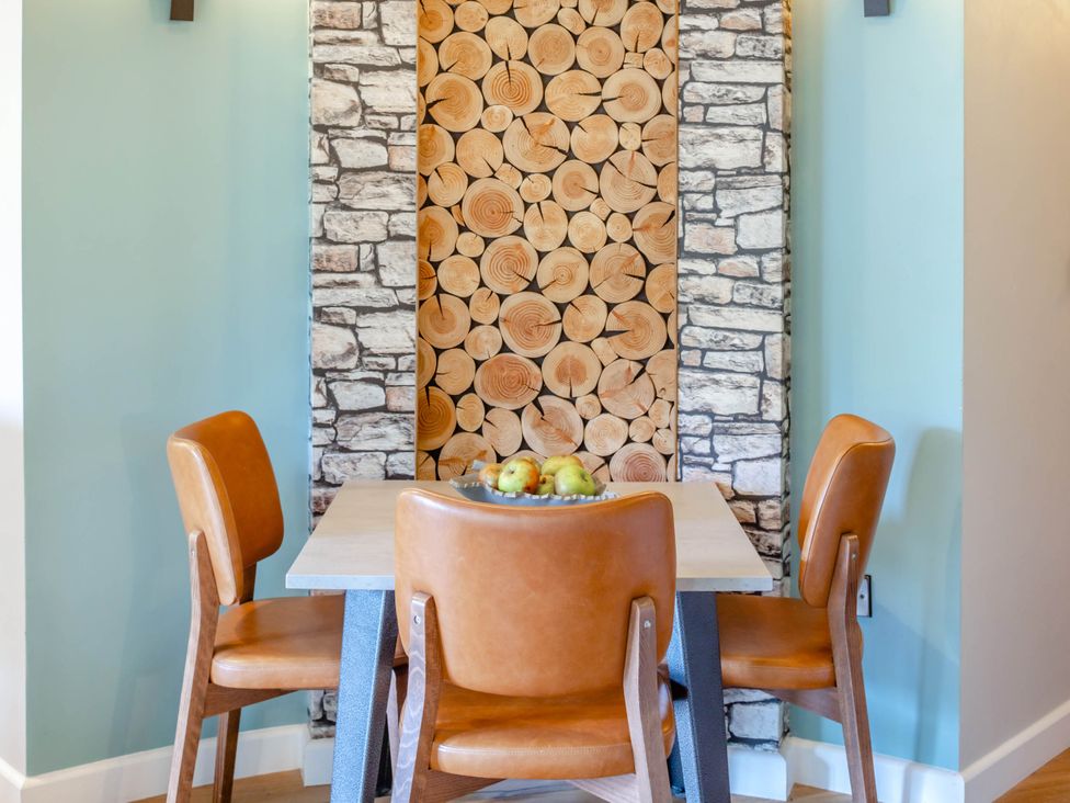 A dining room with a table and chairs at The Treehouse in Praze-An-Beeble