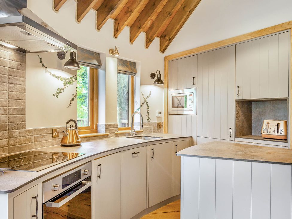 A kitchen with an oven and a sink at The Treehouse in Praze-An-Beeble