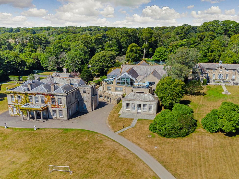 An aerial view of multiple buildings and gardens at The Treehouse in Praze-An-Beeble