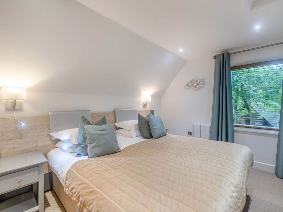A bedroom with a bed and window at St Austell Lodge Spa in Praze-An-Beeble