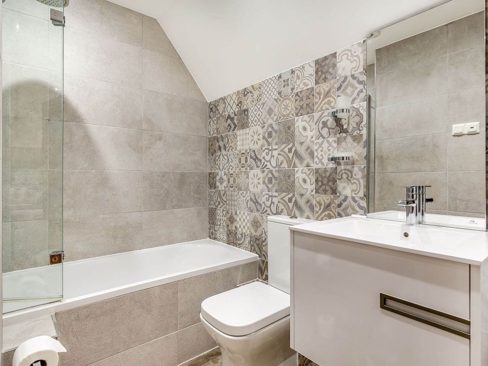 A bathroom with a bathtub and sink at The Gatehouse in Praze-An-Beeble