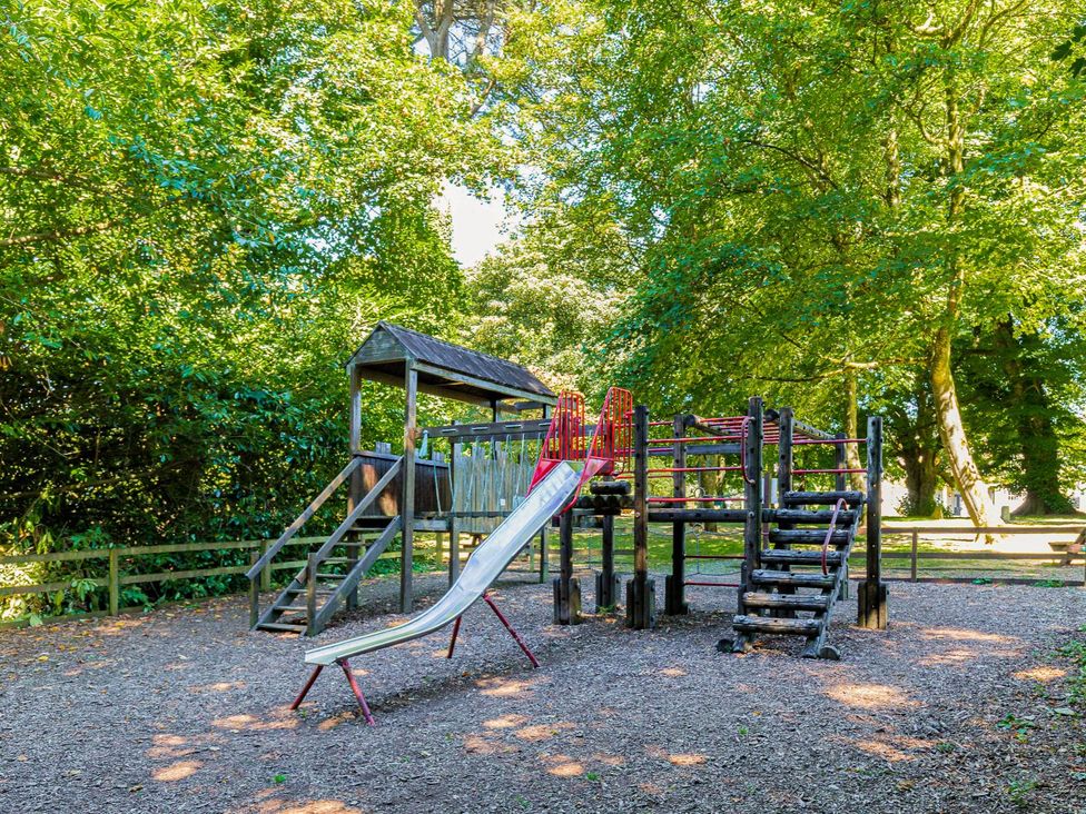 A playground with a slide and climbing frame at Lake View Spa in Praze-An-Beeble