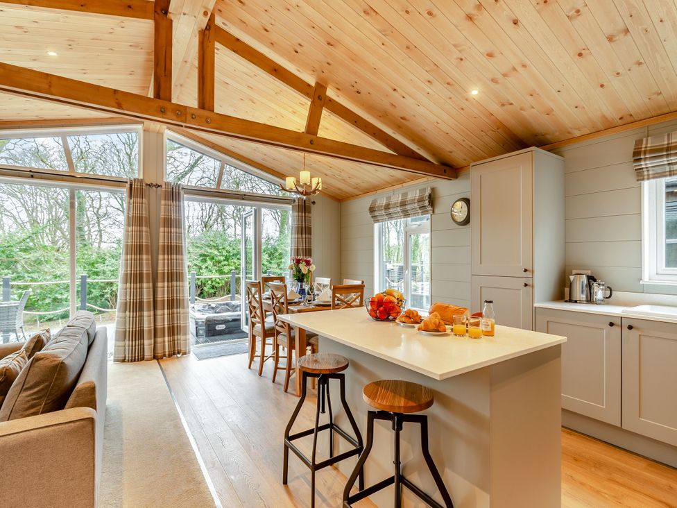 A kitchen with an island and dining area at Argel Spa in Praze-An-Beeble