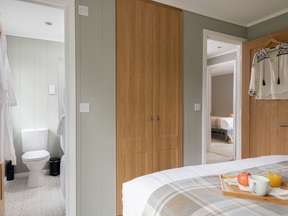A bedroom with a bed and wardrobe at Argel Spa in Praze-An-Beeble