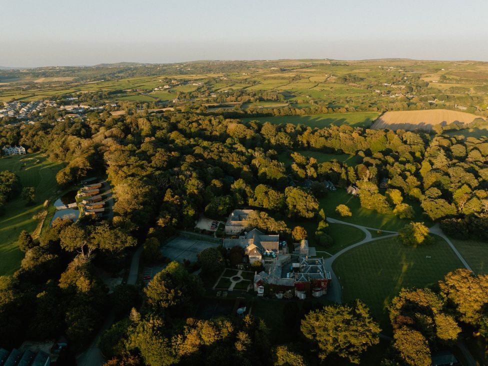 An aerial view of a property surrounded by trees and fields at Argel Spa Pet in Praze-An-Beeble