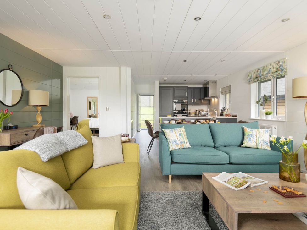 A living room with two sofas and a coffee table at Lowarth Lodge Spa Pet in Praze-An-Beeble