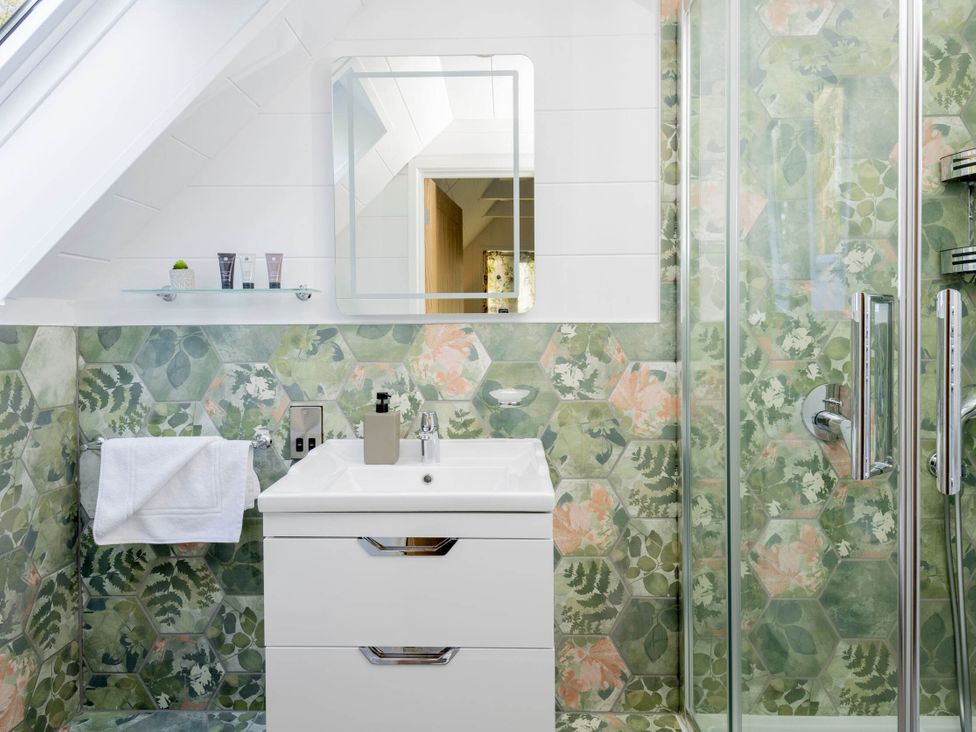 A bathroom with a sink and shower at Lowarth Lodge Spa Pet in Praze-An-Beeble