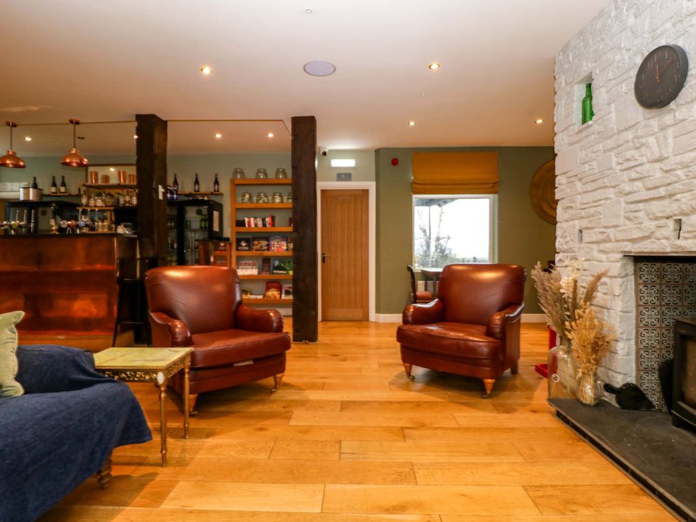 A living room with chairs and a bar at The Swan in 
