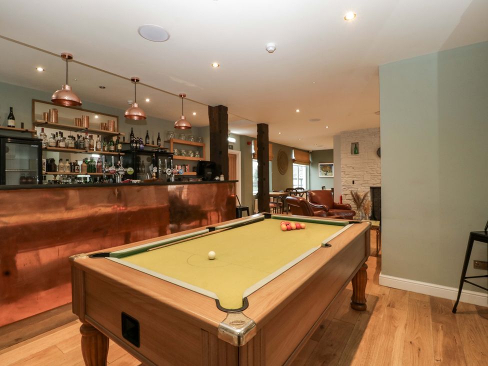 A game room with a pool table and bar at The Swan 