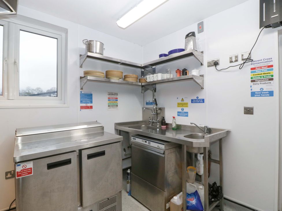 A kitchen with stainless steel equipment and shelves at The Swan