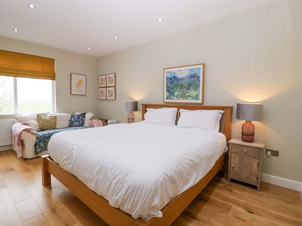 A bedroom with a bed and sofa at The Swan in Whitney-On-Wye