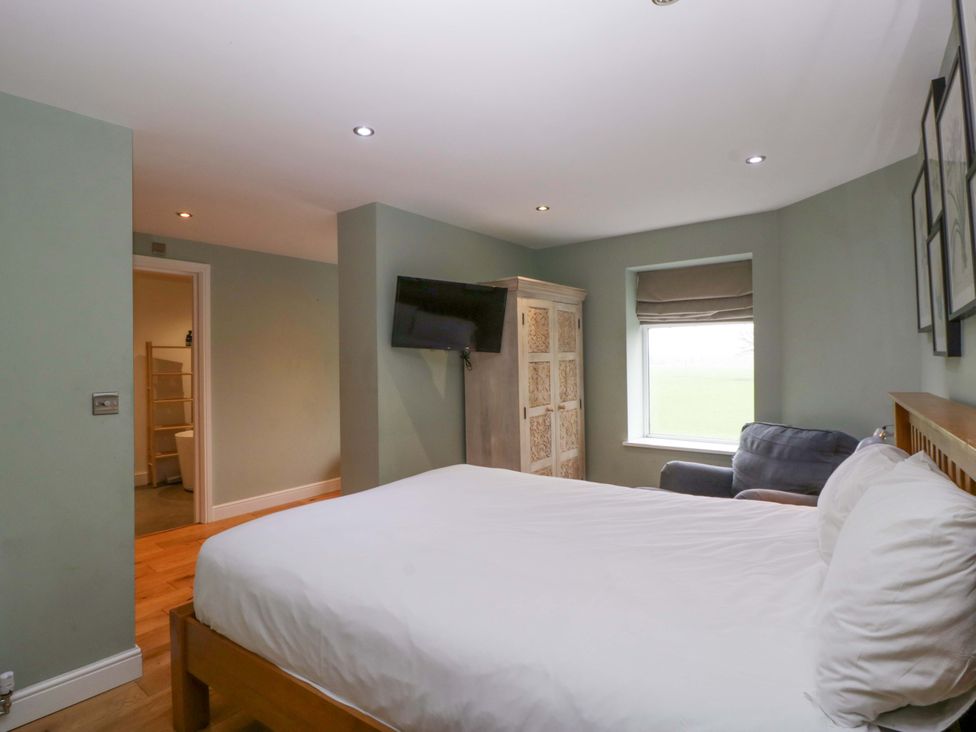 A bedroom with a bed and television at The Swan in Whitney-On-Wye
