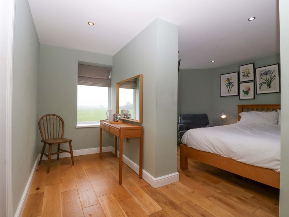 A bedroom with a bed, table, and chair at The Swan in Whitney-On-Wye