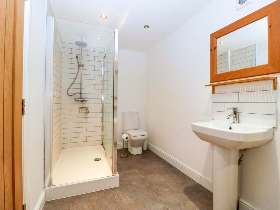 A bathroom with a shower, toilet, and sink at The Swan in Whitney-On-Wye