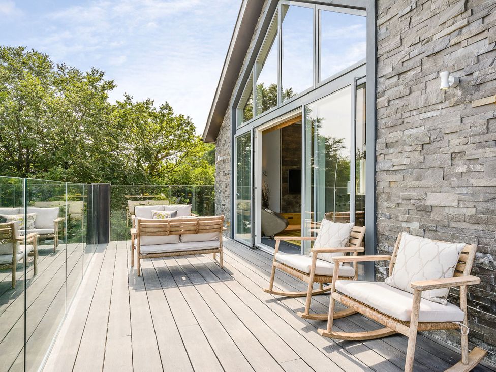 An outdoor deck with rocking chairs and a sofa at The View in Laugharne