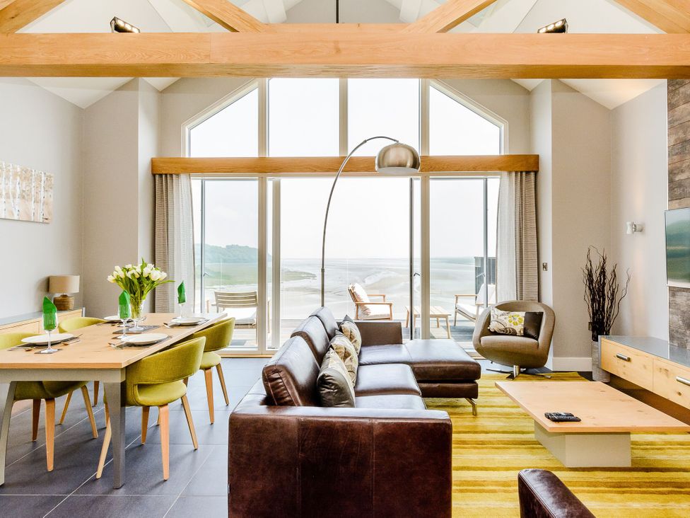A living room and dining area with a view at The View in Laugharne