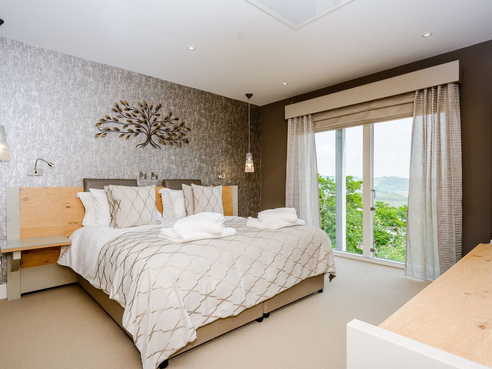 A bedroom with a bed and window at The View in Laugharne
