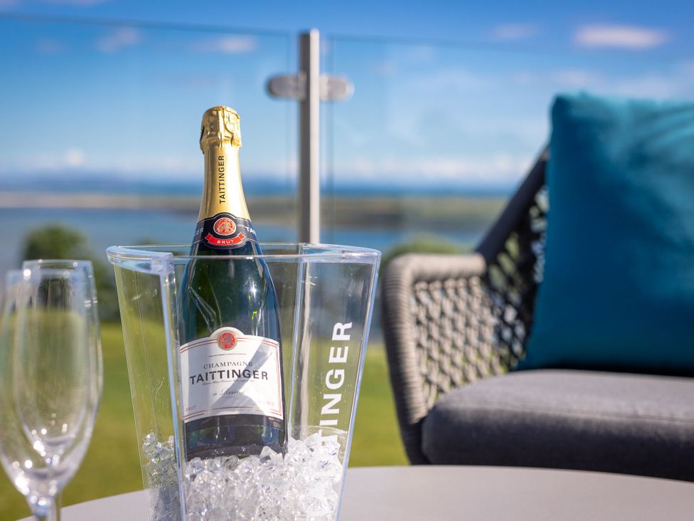 A champagne bottle in an ice bucket with glasses at Apex Spa Laugharne