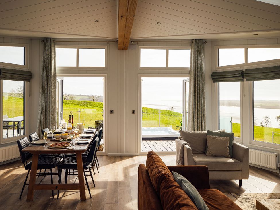 A dining room with a table and chairs at Apex Spa in Laugharne