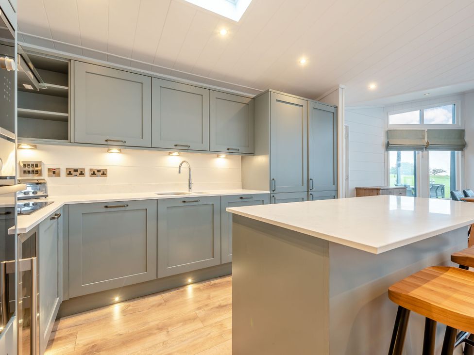 A kitchen with cabinets and a countertop at Apex Spa Laugharne