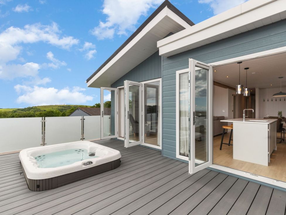 An outdoor terrace with a hot tub at Epic Spa in Laugharne