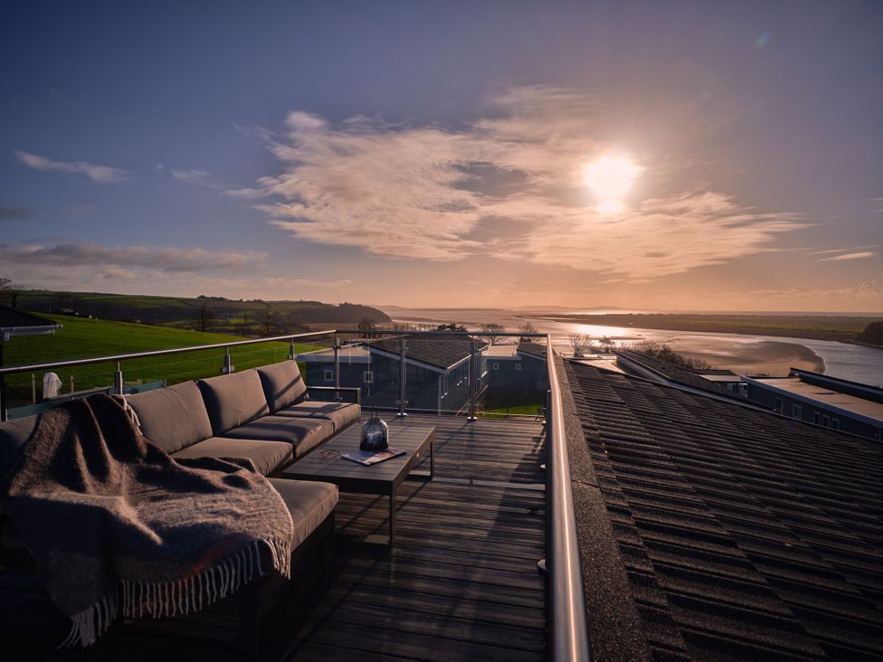 A roof terrace with a sofa and table at Sonnet 3 Spa (Pet) (Roof Terrace) Laugharne