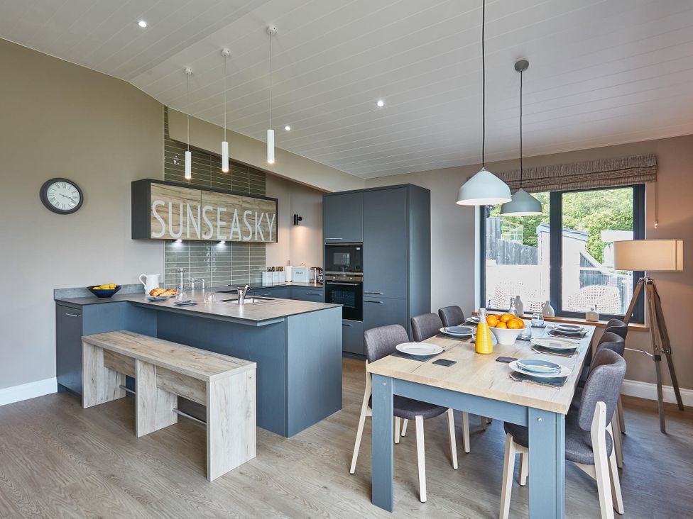 A kitchen with a dining table and chairs at Glan Y Mor in Laugharne
