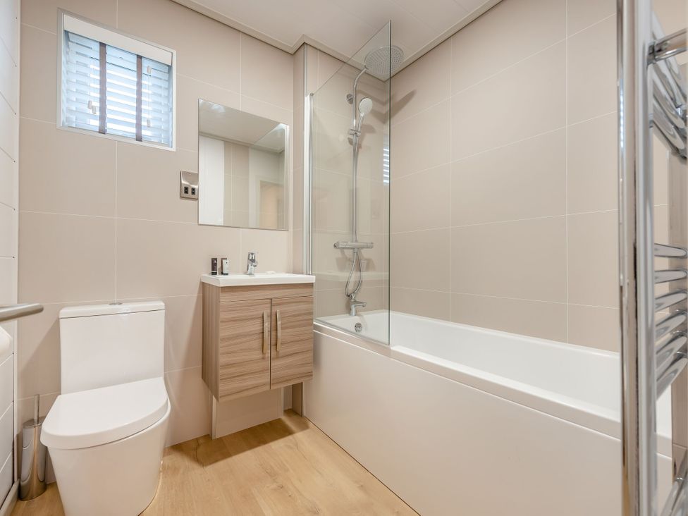 A bathroom with a shower and bathtub at Epic Spa (Roof Terrace) (Pet) in Laugharne