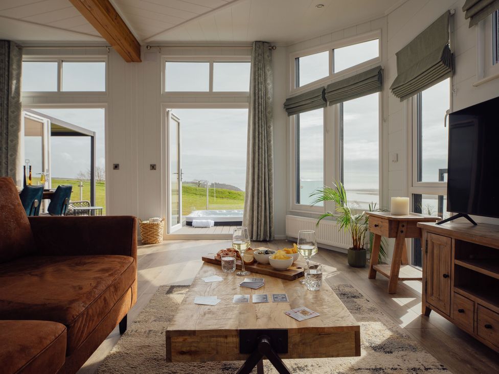 A living room with a coffee table and sofa at Apex Spa (Pet) in Laugharne