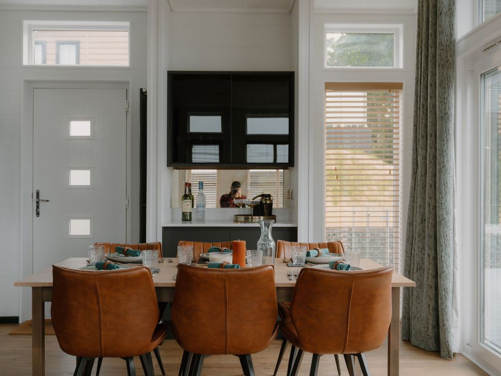 A dining room with a table and chairs at Wilde in Laugharne