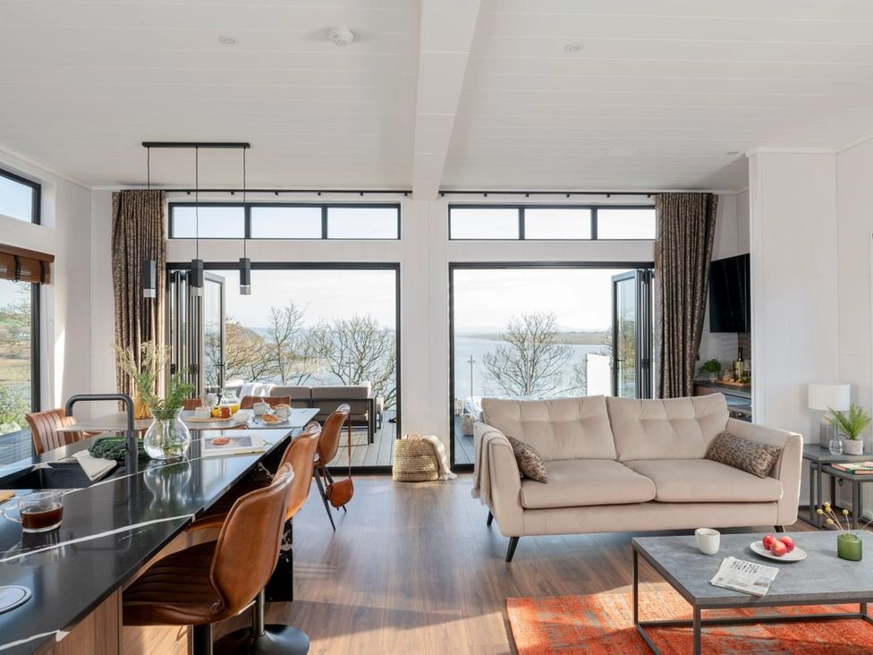 A living room with a sofa and coffee table at Solace in Laugharne