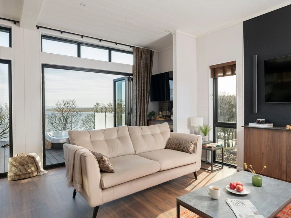 A living room with a sofa and coffee table at Solace in Laugharne