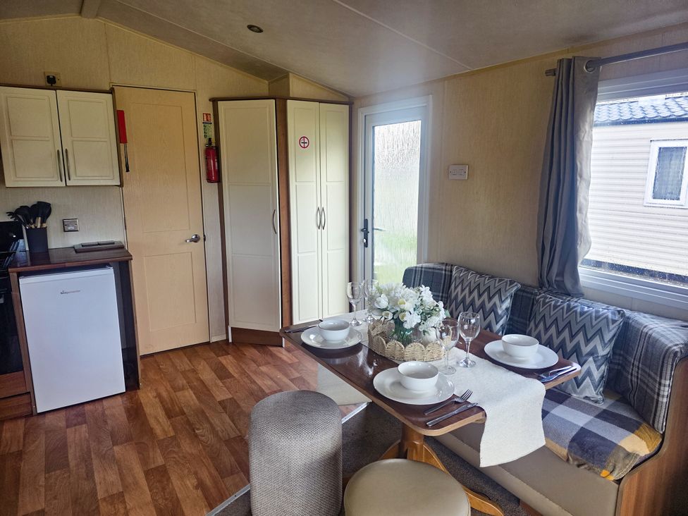 A dining area with table and chairs at Caravan 1 at Blackmoor Farm near Tenby