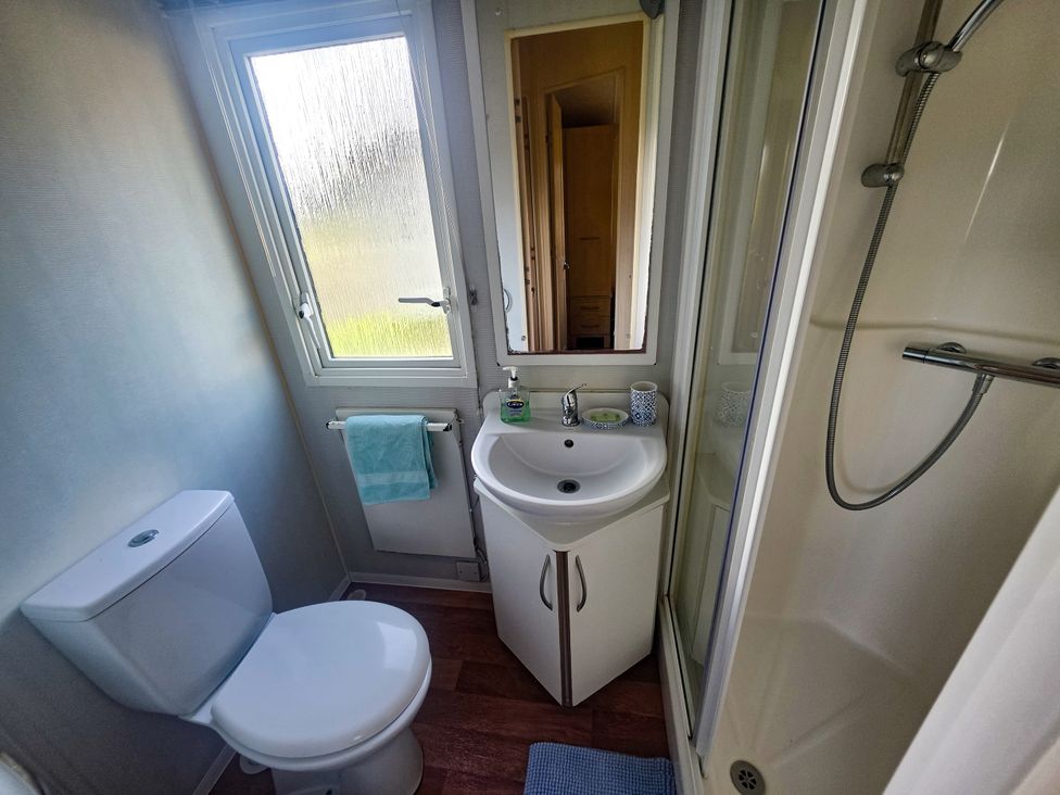 A bathroom with a toilet and a sink at Caravan 1 at Blackmoor Farm near Tenby