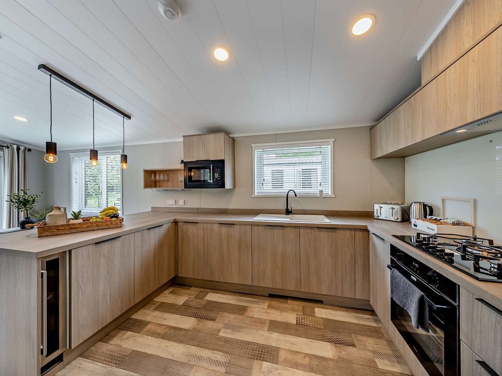 A kitchen with a sink and microwave at Saron 2.0 Pet Llandyrnog