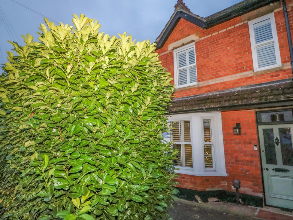 An exterior view of a house with a bush and window at 213 Gordon Avenue Camberley