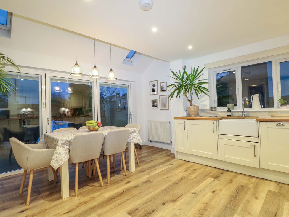 A kitchen with a dining table and chairs at 213 Gordon Avenue Camberley