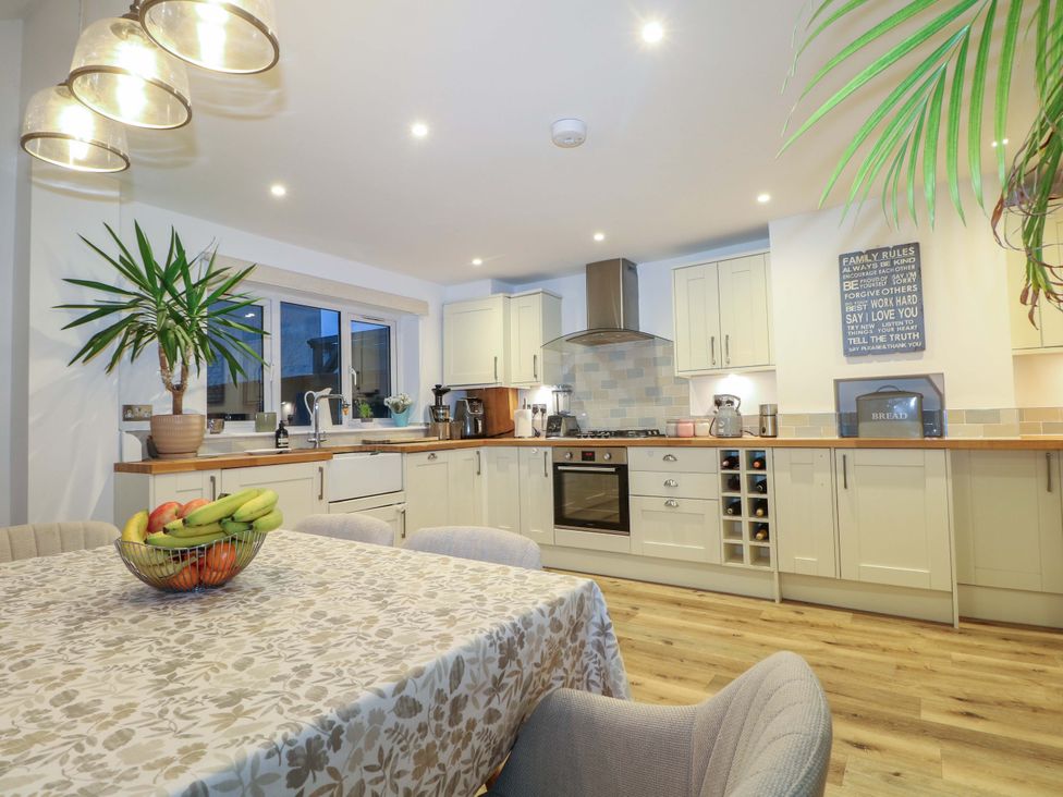 A kitchen with a table and chairs at 213 Gordon Avenue in Camberley