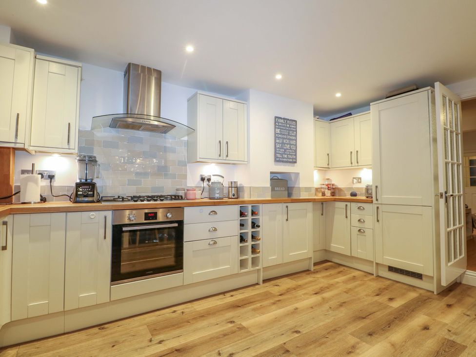 A kitchen with cabinets and appliances at 213 Gordon Avenue Camberley
