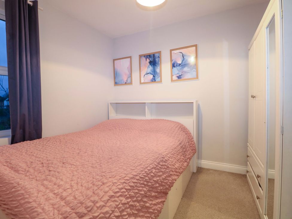 A bedroom with a bed and wardrobe at 213 Gordon Avenue in Camberley