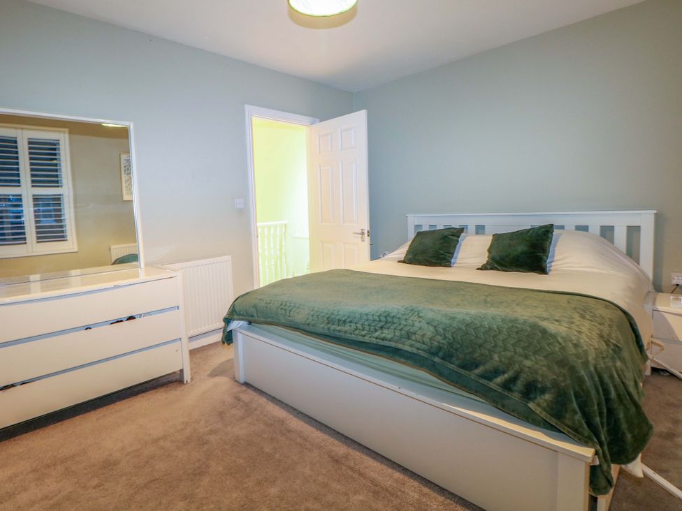 A bedroom with a bed and dresser at 213 Gordon Avenue Camberley