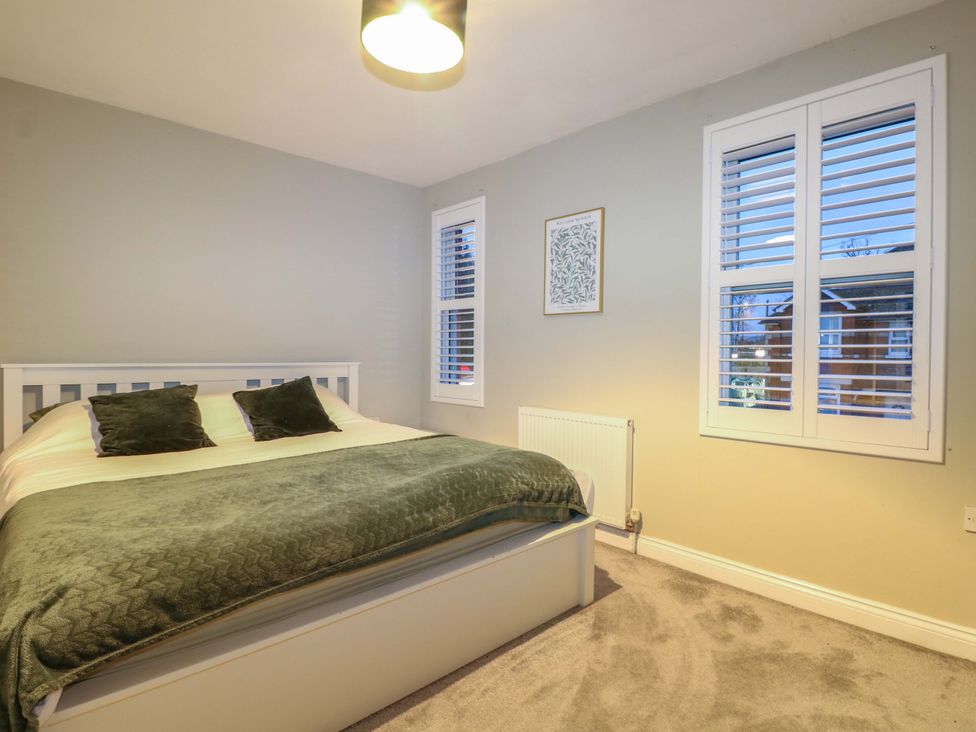 A bedroom with a bed and window at 213 Gordon Avenue, Camberley
