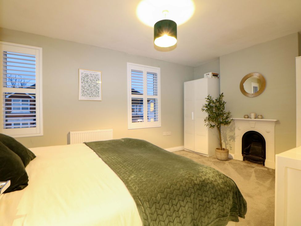 A bedroom with a bed and wardrobe at 213 Gordon Avenue in Camberley