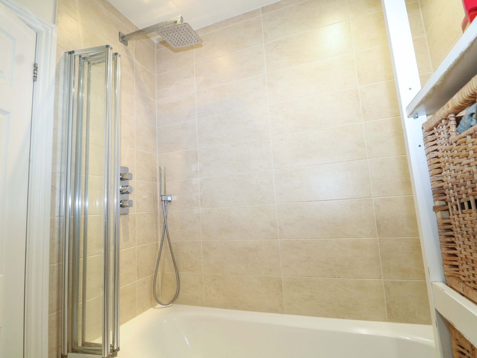 A bathroom with a shower and bathtub at 213 Gordon Avenue Camberley