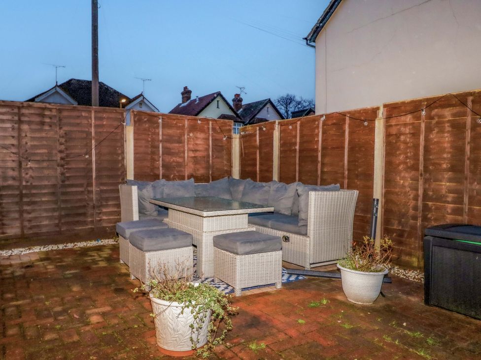 A garden with patio furniture and a planter at 213 Gordon Avenue in Camberley